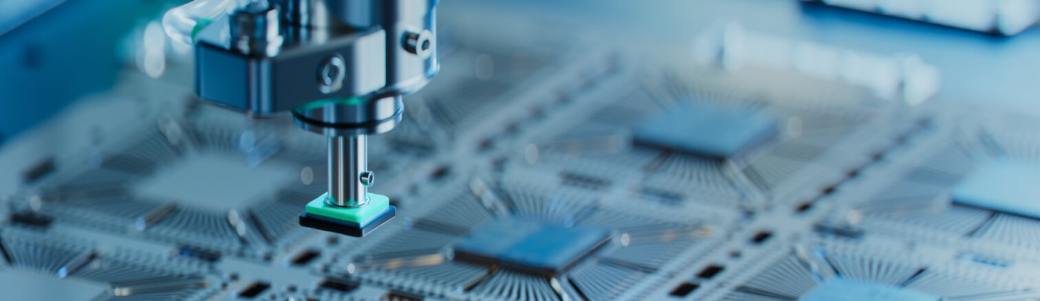 Close up photo of a machine working on computer chips.